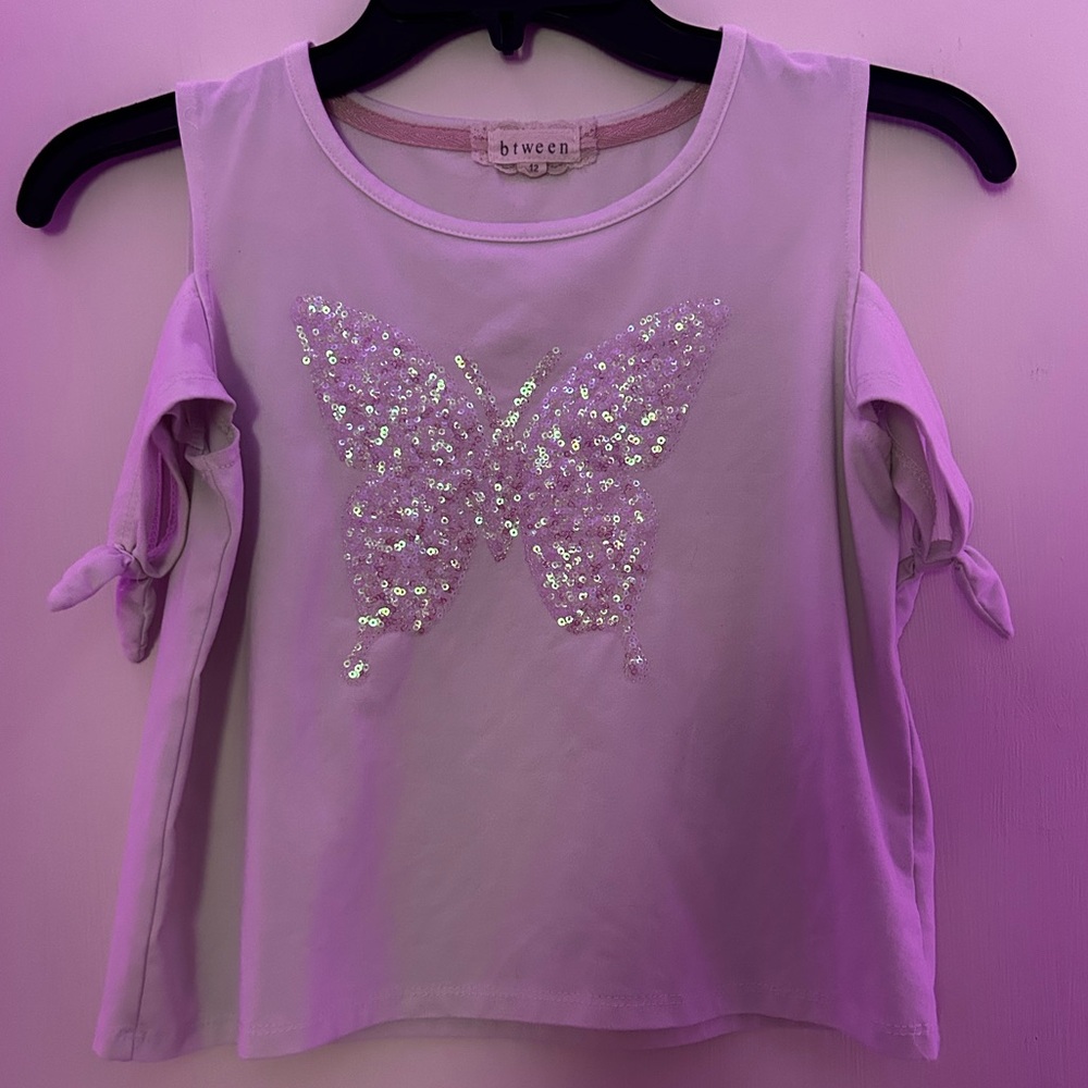 This is a white and pink off the shoulder crop top by btween size kids 12.